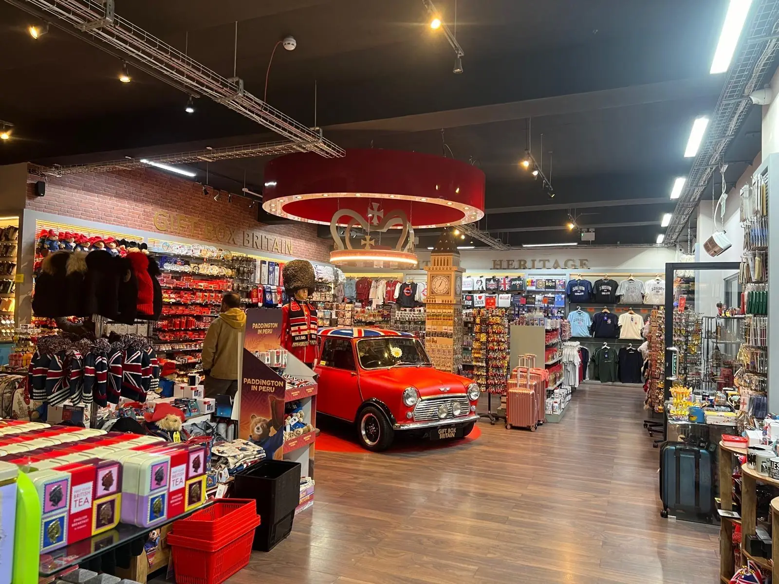 The finished Gift Box Britain store: an illuminated crown pendant and a red Mini set into the floor as a display plinth.